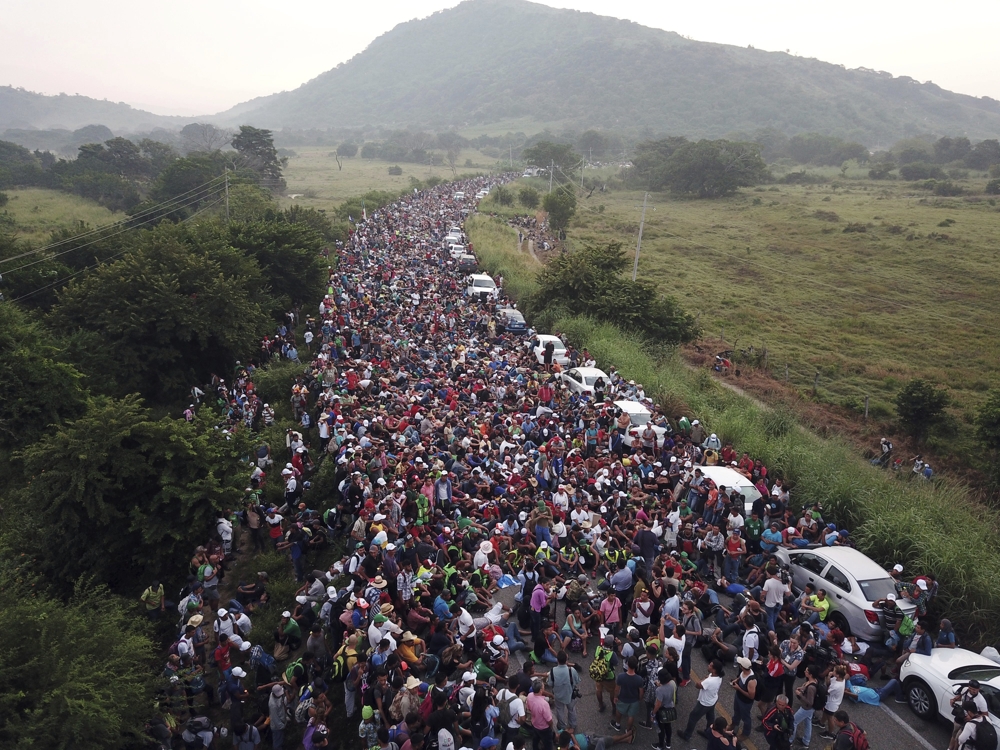 A migrant caravan stood stopped on a road after Mexican federal police blocked their way outside the town of Arriaga Mexico